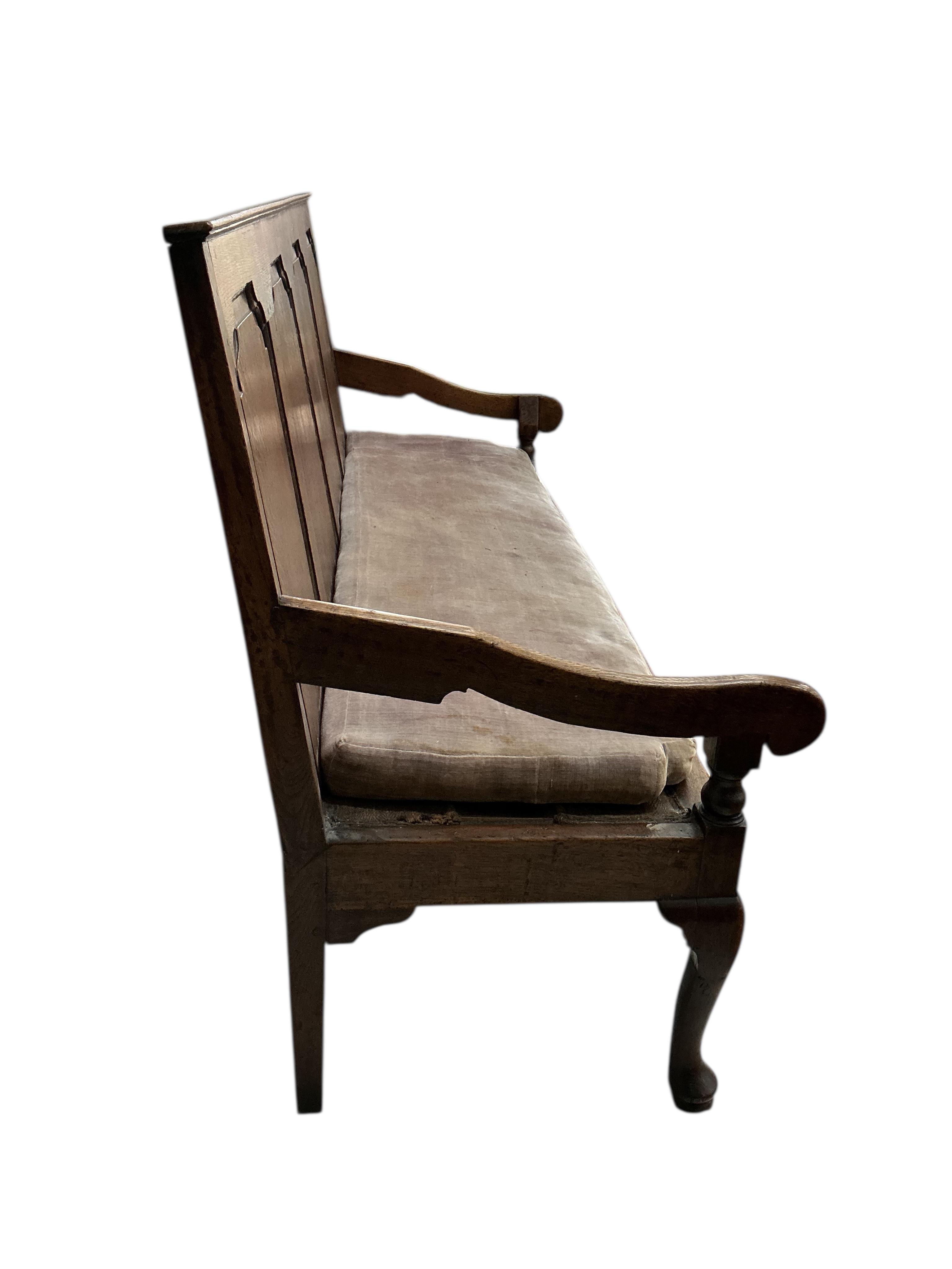A George III oak settle, width 184cm, depth 64cm, height 107cm